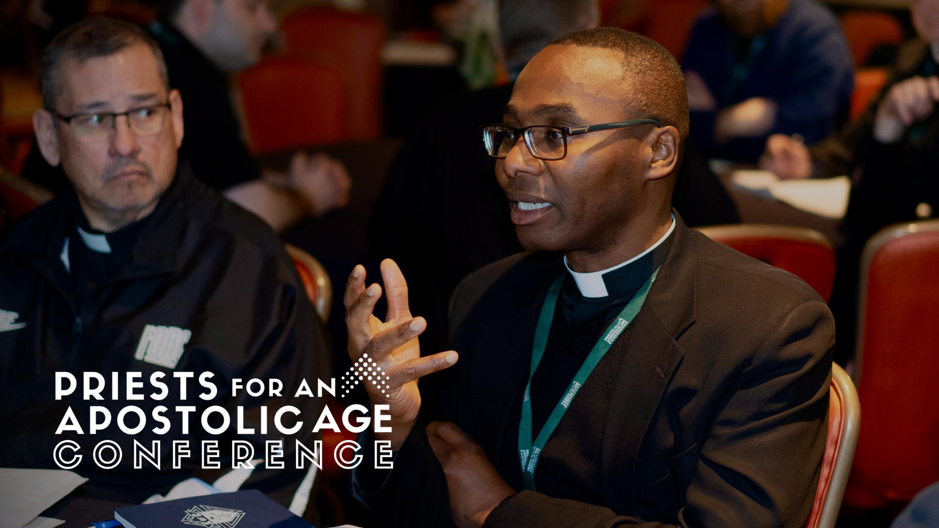 Priests talking together at a tablke