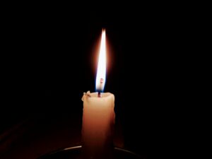 Single candle in the dark